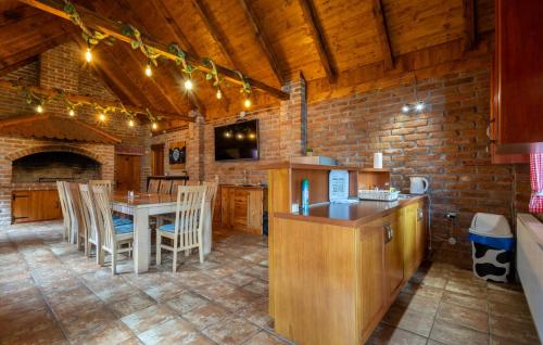 a kitchen with a table and chairs in a room at Awesome Home In Novo Zvecevo With Sauna in Novo Zvecevo