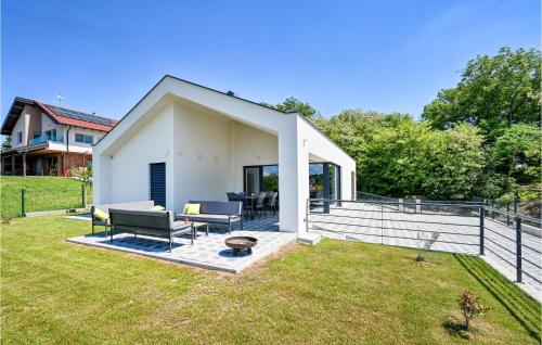 a white house with a patio and grass at Cozy Home In Dugo Selo With Sauna in Dugo Selo