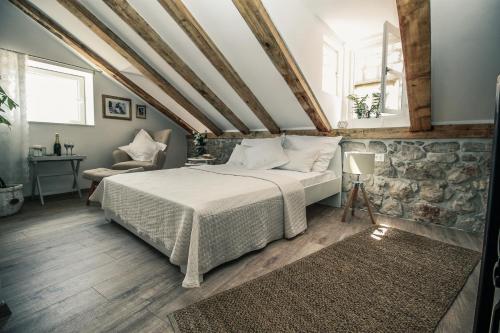 a bedroom with a bed and a stone wall at Apartments St. Michel in Dubrovnik