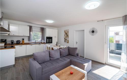 a living room with a couch and a kitchen at 2 Bedroom Lovely Apartment In Obrovac in Obrovac