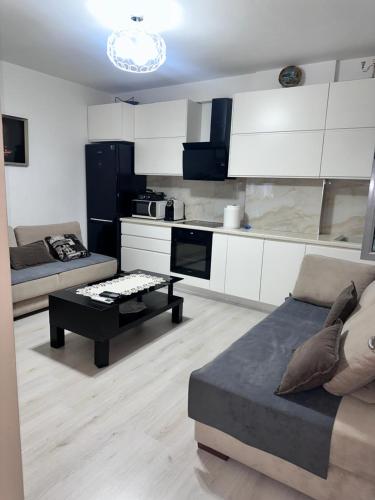 a living room with a couch and a table at Apartament Arena 2 in Elbasan