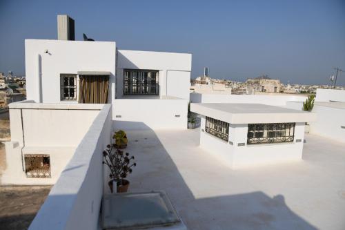 a view of a white building on a roof at Dar Hamouda Guest House - Médina de Tunis in Tunis