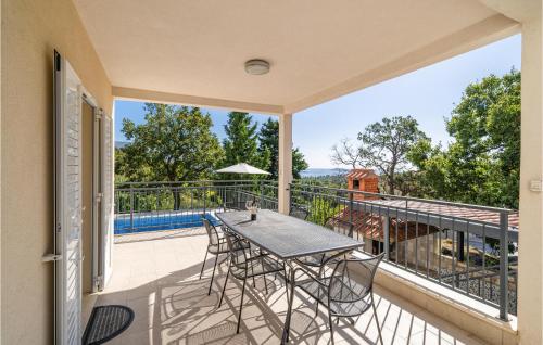 a patio with a table and chairs on a balcony at Stunning Home In Mlini in Mlini