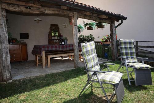 two chairs and a table in a yard at Casa Pracol in Combai