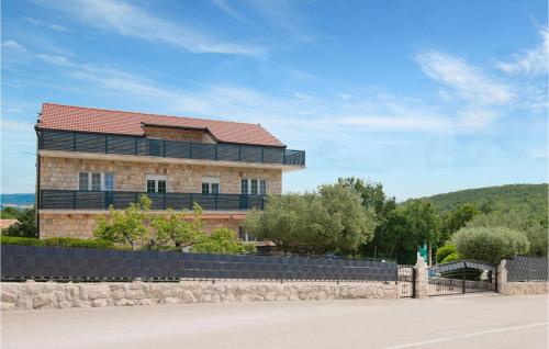 a large brick building with a red roof at Lovely Home In Podbablje Gornje in Podbablje