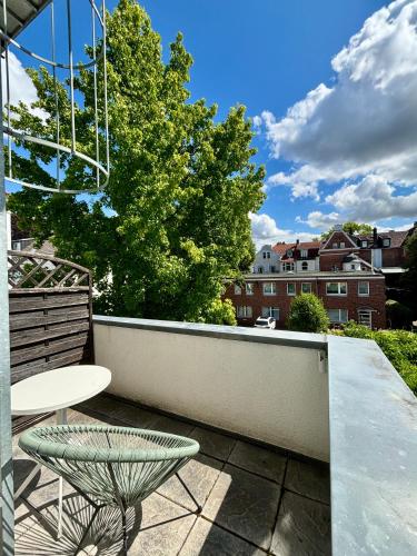 a patio with a table and a chair on a balcony at Pension Am Sültebrunnen in Bad Oeynhausen