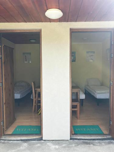 a room with two doors and a room with two beds at Domek przy Base Camp Pieniny in Niedzica Zamek
