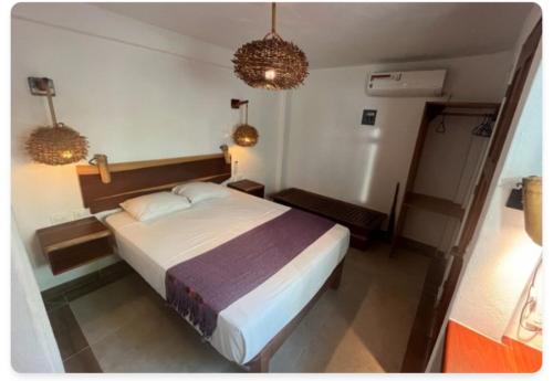 a bedroom with a large bed in a room at Casa Lamat in Bacalar