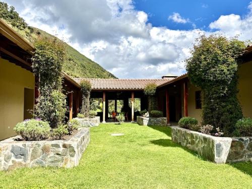 an exterior view of a house with a yard at Heated & Cozy Cabin in Nature in Cuenca