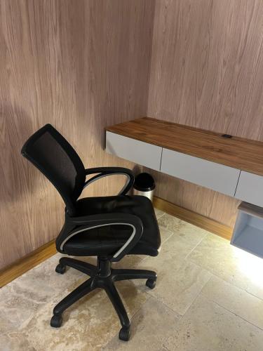a black chair in a room with a desk at Heated & Cozy Cabin in Nature in Cuenca