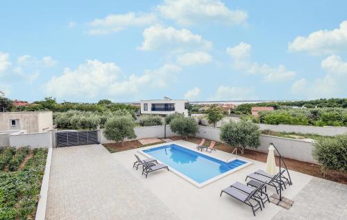 a swimming pool on the roof of a house at 4 Bedroom Gorgeous Home In Vrsi in Vrsi