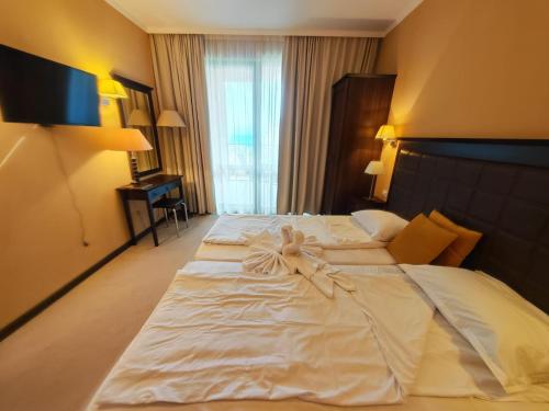 a large white bed in a hotel room at Royal Barcelo G404 Sunny Beach in Sunny Beach