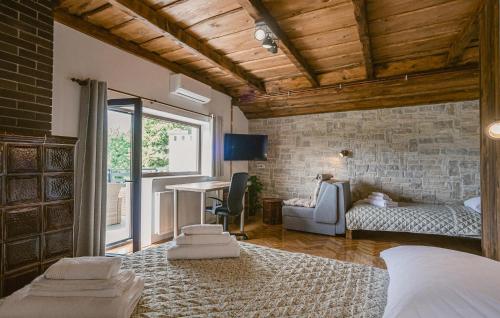 a bedroom with a bed and a desk in a room at Lovely Home In Lepoglava With Sauna in Lepoglava