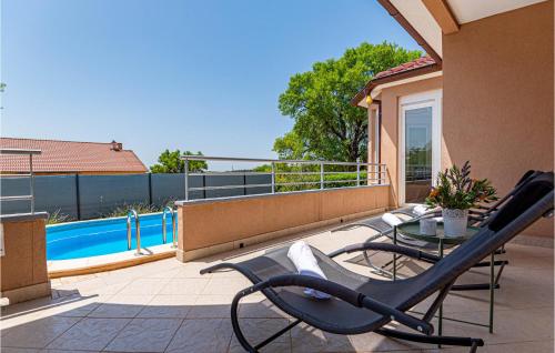 a patio with a table and chairs on a balcony at 3 Bedroom Awesome Home In Badanj in Drniš