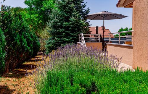 a patio with an umbrella next to a building at 3 Bedroom Awesome Home In Badanj in Drniš