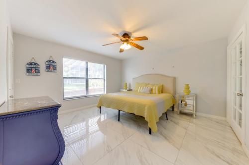 a bedroom with a bed and a ceiling fan at 1 Mi to Lantana Beach Canal-View Condo with Pool in Atlantis