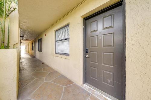 an empty hallway with a door in a building at 1 Mi to Lantana Beach Canal-View Condo with Pool in Atlantis