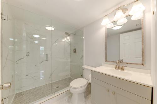 a bathroom with a shower and a toilet and a sink at 1 Mi to Lantana Beach Canal-View Condo with Pool in Atlantis
