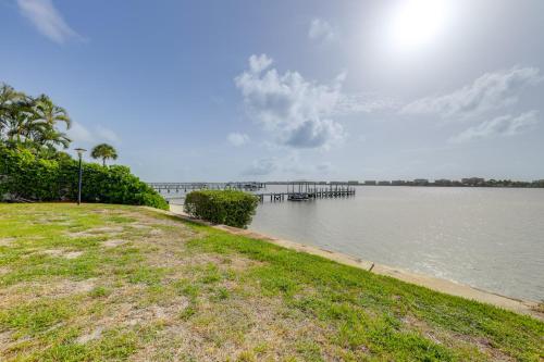 a large body of water with a pier in the distance at 1 Mi to Lantana Beach Canal-View Condo with Pool in Atlantis