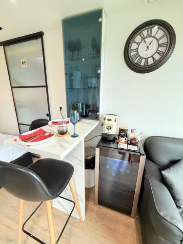 a kitchen with a table and a clock on the wall at 446 Tiny House Shirokë in Široka