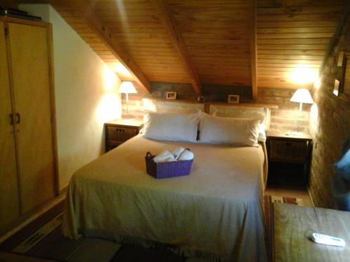 a bedroom with a bed with a box on it at Cabañas Ailen in Sierra de la Ventana