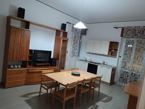 a kitchen and dining room with a table and chairs at Casa Vacanze Salento in Matino