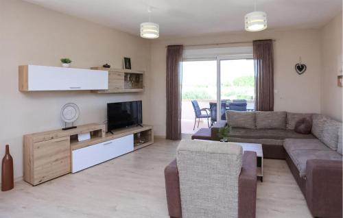 a living room with a couch and a tv at Luxurious Home In Vrsi in Vrsi