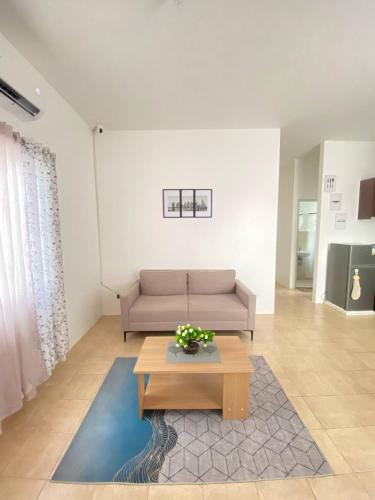 a living room with a couch and a coffee table at Lady Liberty Residence in Panglao