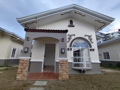 a small white house with a front door at Lady Liberty Residence in Panglao