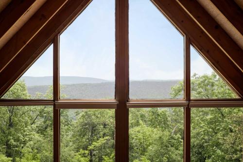 una vista da una finestra in una cabina di Cozy w 5 Private Acres Deck Grill & Dog Friendly a Slanesville