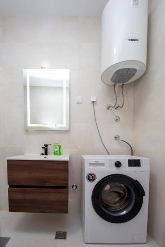 a washing machine in a bathroom with a sink at Adriatic calm Terrace & Parking in Becici
