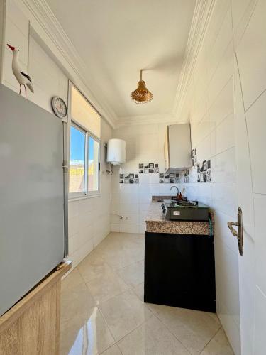 a bathroom with a sink and a counter and a window at Namaste Lodge Experience in Taghazout