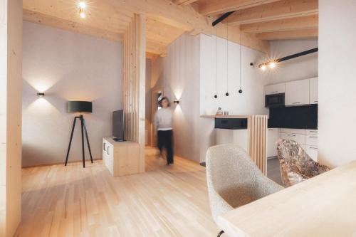 a man is standing in a living room in a apartment at Die Lecherin in Lech am Arlberg