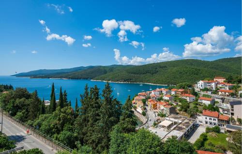 a view of a town next to a body of water at 1 Bedroom Awesome Apartment In Rabac in Rabac