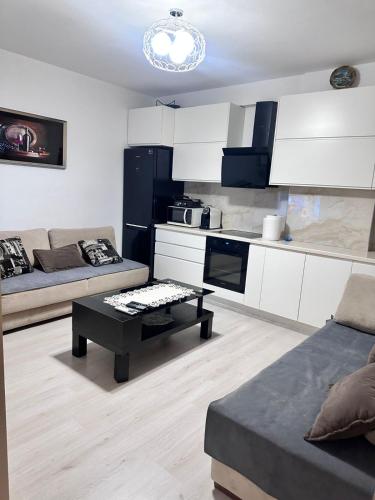 a living room with a couch and a table at Apartament Arena 2 in Elbasan