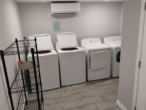 a laundry room with four washes and a drying rack at The Dolphin Watch Near the Beach in FWB - Unit 7 in Fort Walton Beach