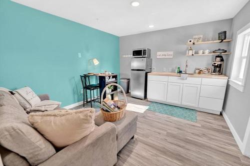 a living room with a couch and a kitchen at Sunset Dream Minutes from the Beach - Unit 8 in Fort Walton Beach