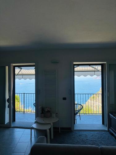 a living room with a view of the ocean at Loft Il Castello con terrazza sul mare in Riomaggiore