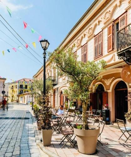 a street with tables and chairs and a street light at 446 Tiny House Shirokë in Široka