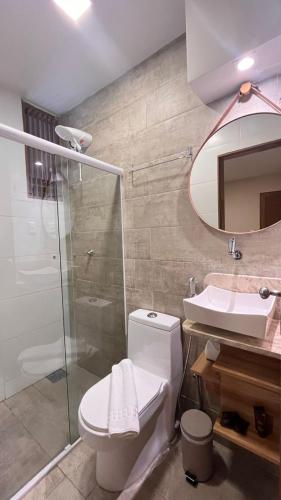 a bathroom with a toilet and a sink and a shower at Casarão Suítes Maragogi in Maragogi