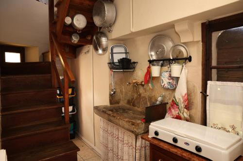 a kitchen with a sink and some pots and pans at Casa Pracol in Combai