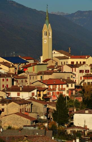 a town with a church with a clock tower at Casa Pracol in Combai