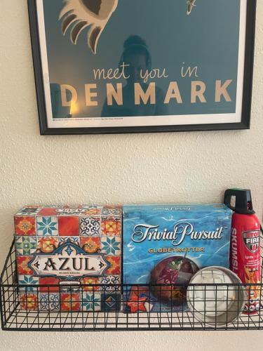 a shelf with food and a picture on the wall at Charming rooftop apartment in Uhre in Brande