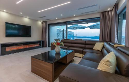 a living room with a couch and a fireplace at Awesome Home In Crikvenica With Sauna in Crikvenica