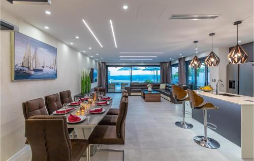 a dining room and living room with a table and chairs at Awesome Home In Crikvenica With Sauna in Crikvenica