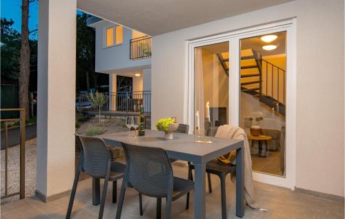 a dining table and chairs on a patio at Stunning Home In Kraljevica With Wifi in Kraljevica