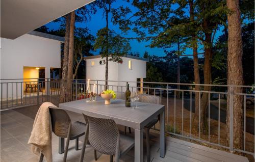 a table and chairs on the deck of a house at Stunning Home In Kraljevica With Wifi in Kraljevica