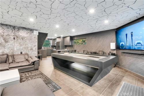 a living room with a large couch and a large tub at Modern Mountain Luxury Soak, Stay, & Be Spoiled in Shaver Lake