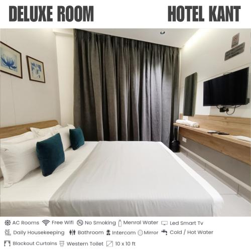 a hotel room with a large bed and a television at KANT by GoHotels - Near Shree Dwarkadhish Temple in Dwarka