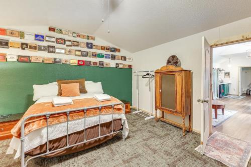 a bedroom with a bed and a green wall at 5 Mi to Lake Ouachita Peaceful Cabin Retreat in Royal